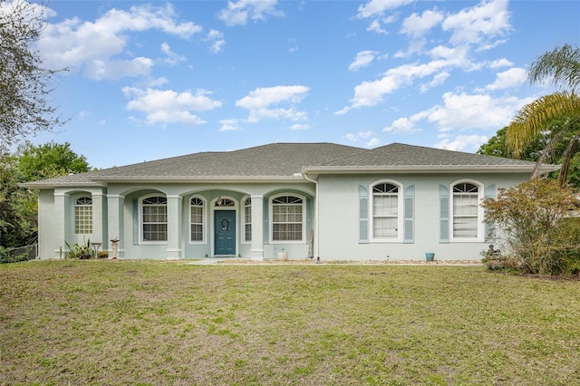 ranch-style home with a front lawn and stucco siding