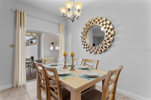 dining room with light tile patterned floors, baseboards, and an inviting chandelier