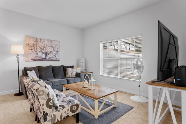 living area featuring light tile patterned floors and baseboards