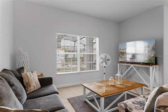 living area featuring baseboards and light tile patterned floors