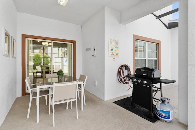 carpeted dining room with a chandelier