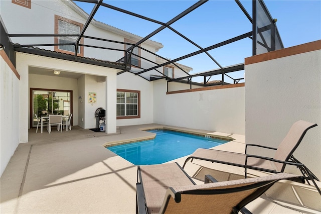 outdoor pool with a lanai, a patio, and outdoor dining area