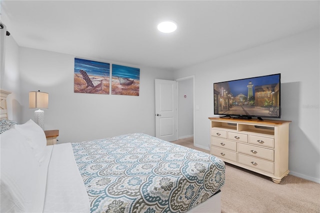 bedroom with baseboards and light colored carpet