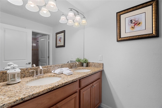 bathroom featuring a shower, a sink, and double vanity