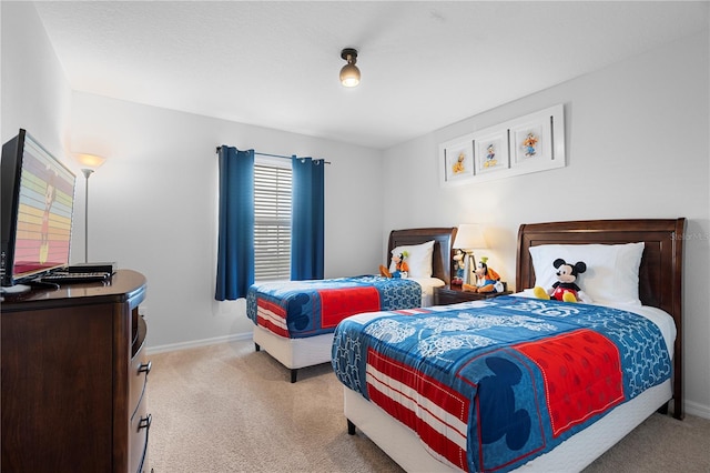 bedroom featuring light carpet and baseboards