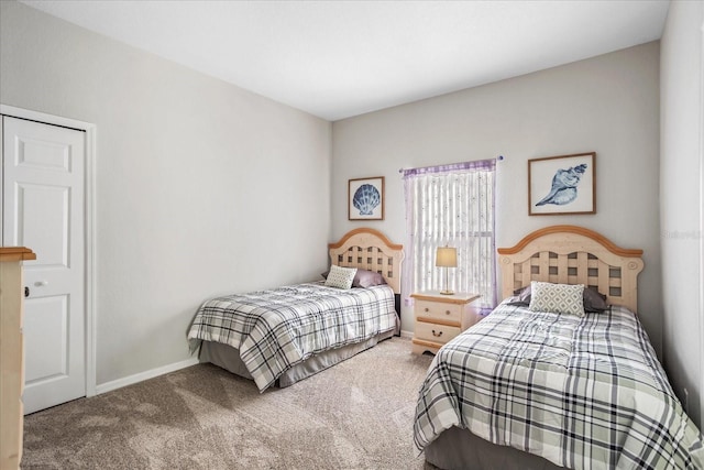 carpeted bedroom featuring baseboards