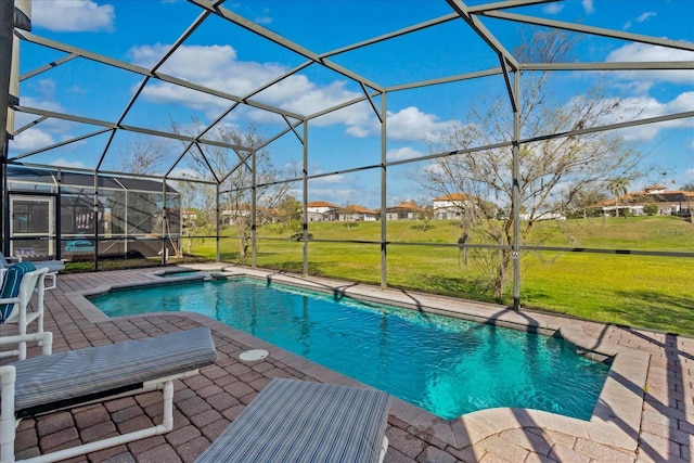 outdoor pool with a yard, glass enclosure, a patio area, and an in ground hot tub