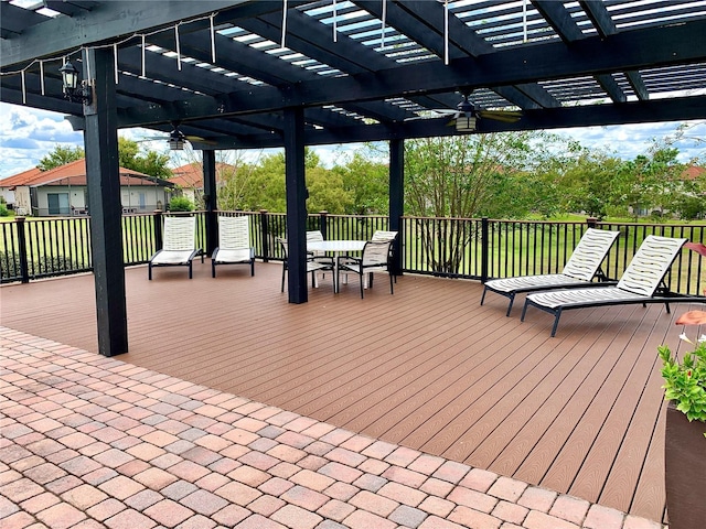 wooden terrace with a pergola and outdoor dining space