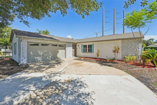 ranch-style house with a garage, driveway, and stucco siding