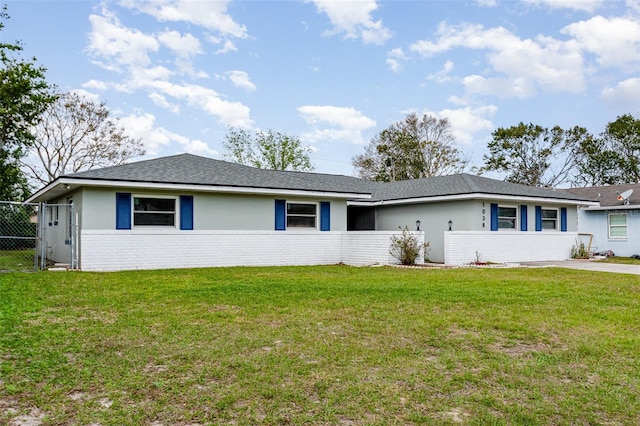 ranch-style house with a gate, brick siding, fence, and a front lawn