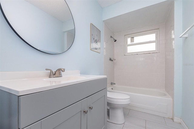 bathroom featuring tile patterned flooring, bathing tub / shower combination, toilet, and vanity