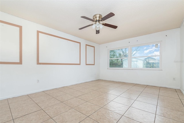 unfurnished room with light tile patterned floors, a textured ceiling, and a ceiling fan