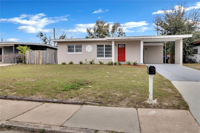 view of front of property with a carport, a front yard, driveway, and fence