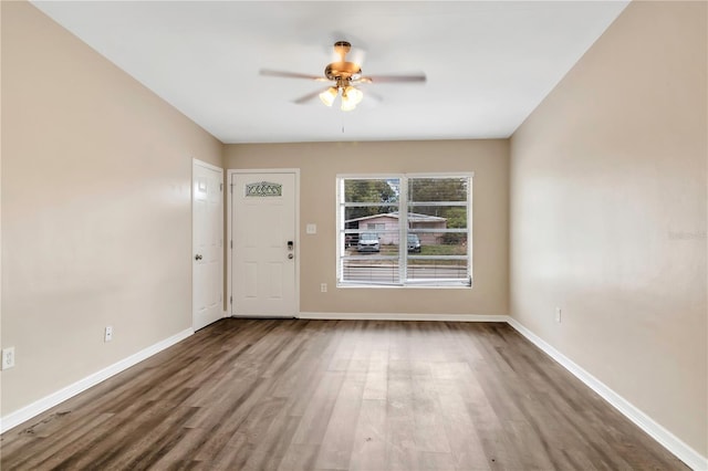 interior space featuring ceiling fan, baseboards, and wood finished floors