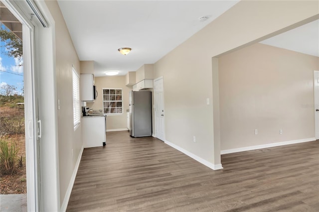 interior space with baseboards and wood finished floors