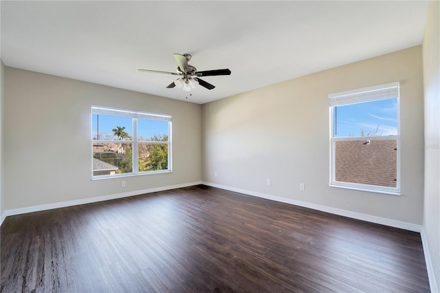 empty room with a ceiling fan, baseboards, and dark wood-style flooring