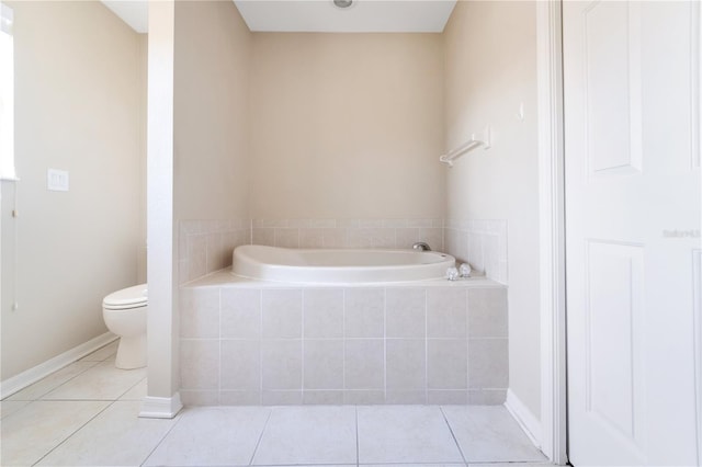 bathroom with a garden tub, tile patterned flooring, toilet, and baseboards