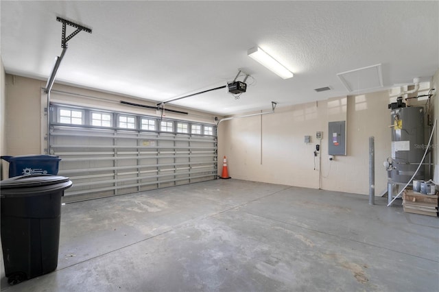 garage featuring water heater, electric panel, and a garage door opener