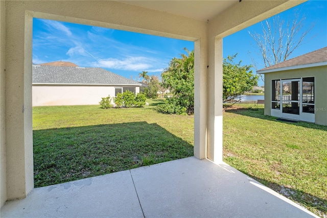 view of yard featuring a patio area and a water view