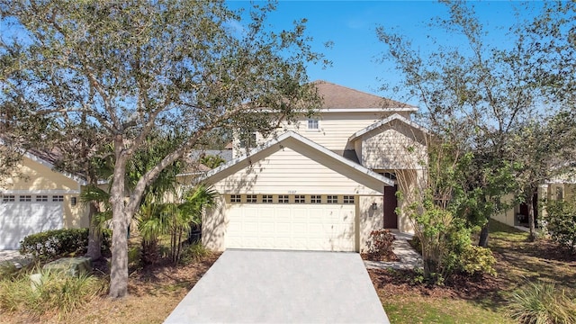 traditional-style home with a garage and concrete driveway