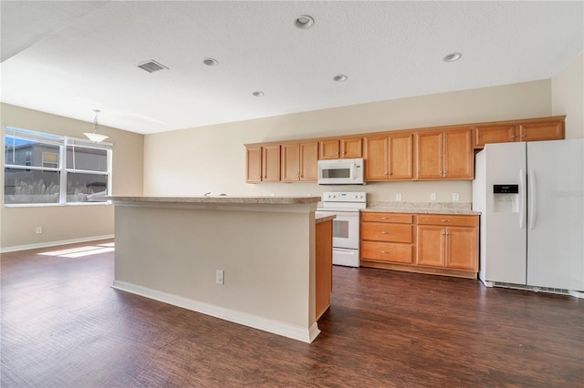 kitchen featuring light countertops, white appliances, dark wood-type flooring, and visible vents