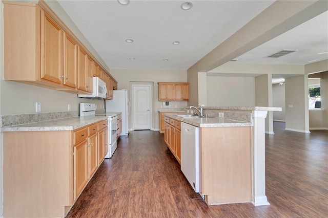 kitchen with dark wood finished floors, light countertops, visible vents, a sink, and white appliances