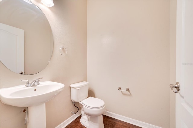 bathroom featuring wood finished floors, toilet, and baseboards