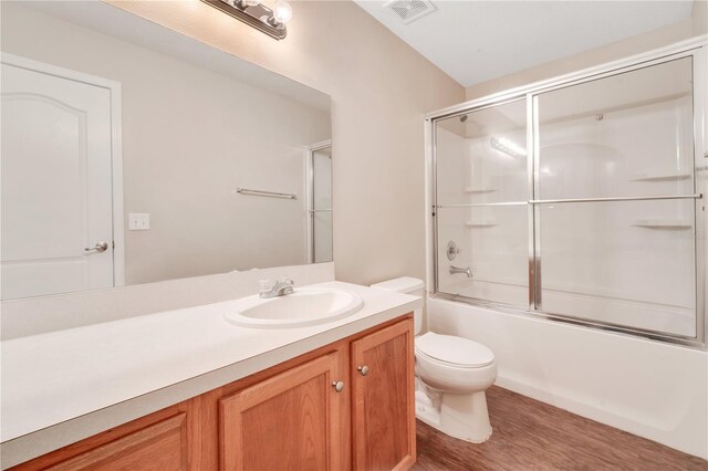 full bath with visible vents, toilet, enclosed tub / shower combo, vanity, and wood finished floors