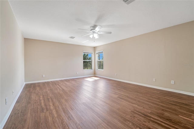 spare room with a ceiling fan, a textured ceiling, baseboards, and wood finished floors