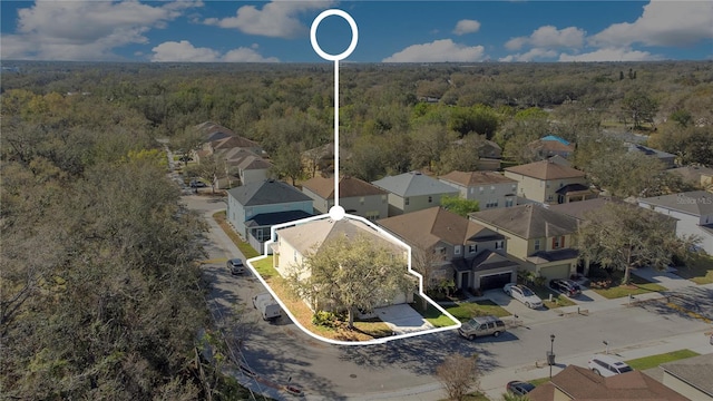 birds eye view of property featuring a residential view and a view of trees