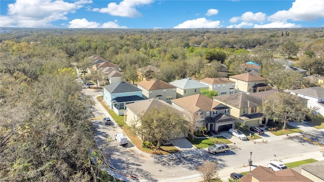 drone / aerial view with a residential view and a view of trees