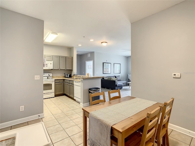 dining area with light tile patterned floors and baseboards