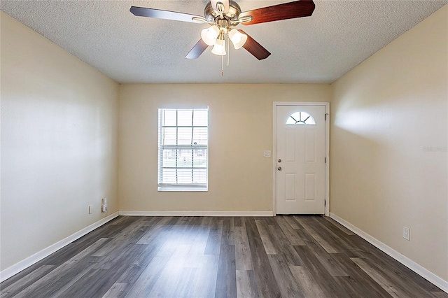 entryway with ceiling fan, a textured ceiling, baseboards, and dark wood-type flooring