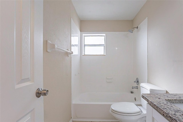 bathroom featuring tub / shower combination, vanity, and toilet