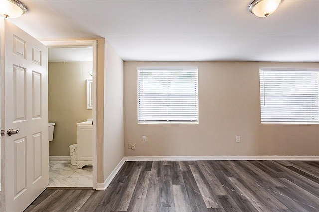 interior space featuring baseboards and wood finished floors