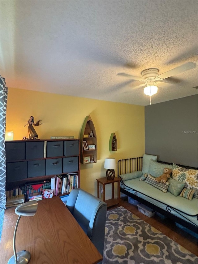 bedroom featuring ceiling fan, a textured ceiling, and wood finished floors