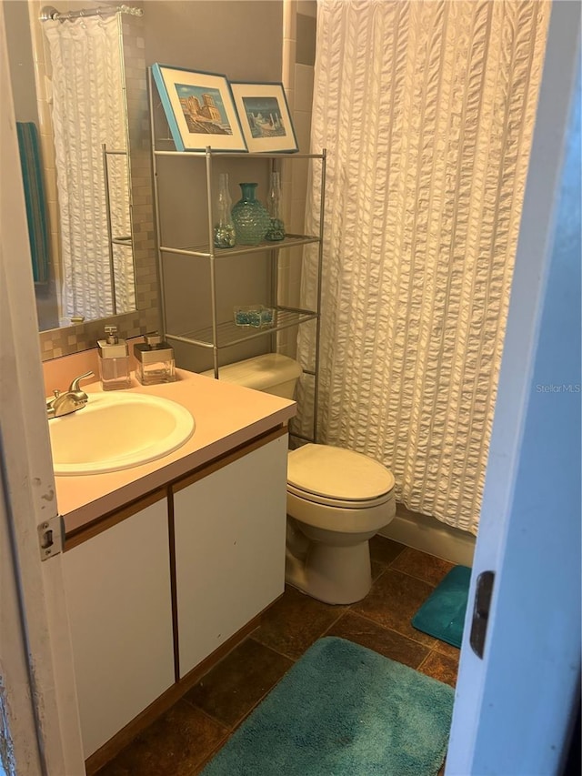 full bath with a shower with curtain, toilet, vanity, and tile patterned flooring