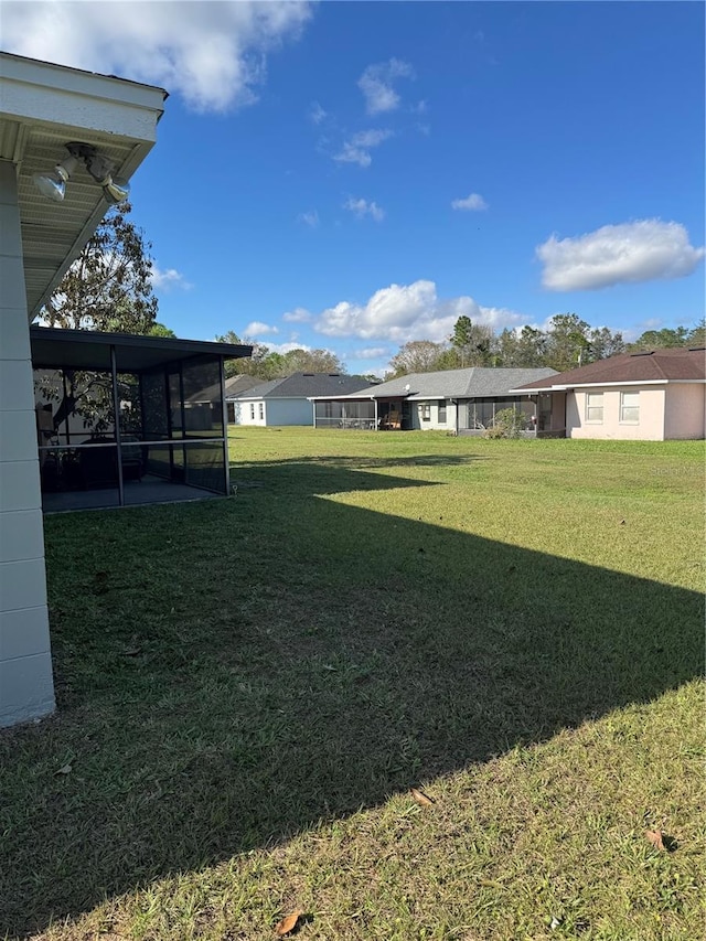 view of yard with a sunroom