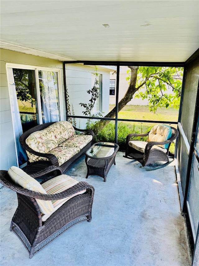 sunroom with an outdoor living space and a healthy amount of sunlight
