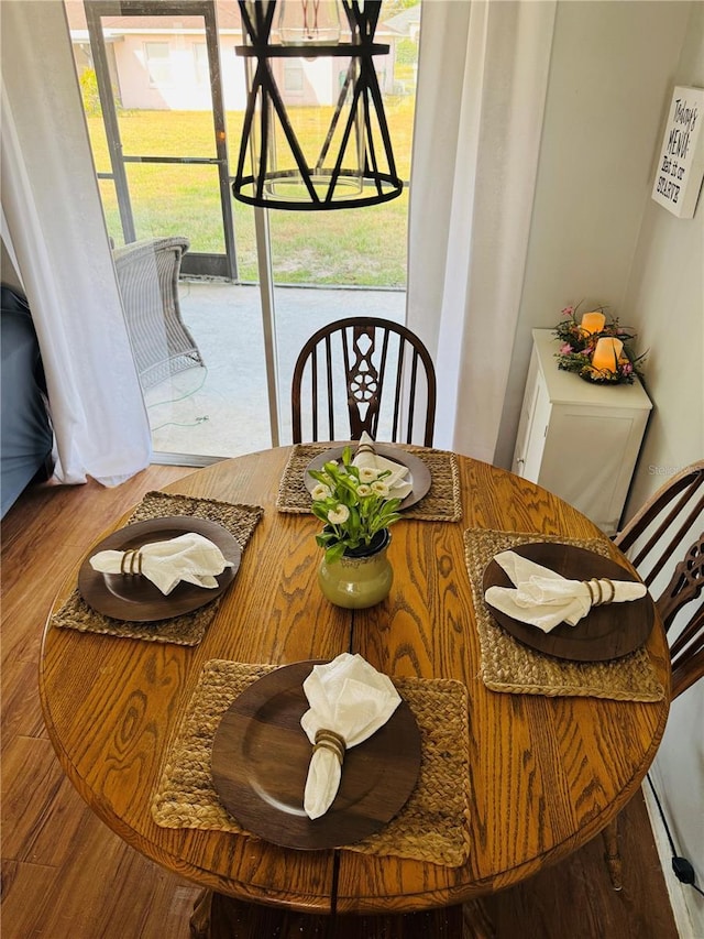 dining room with a healthy amount of sunlight and wood finished floors