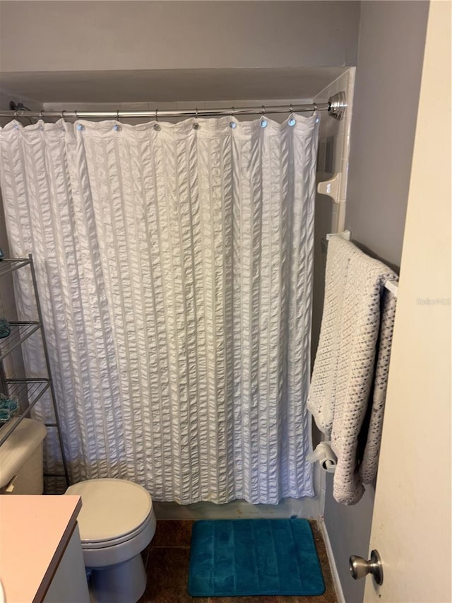 full bath with a shower with curtain, vanity, tile patterned flooring, and toilet