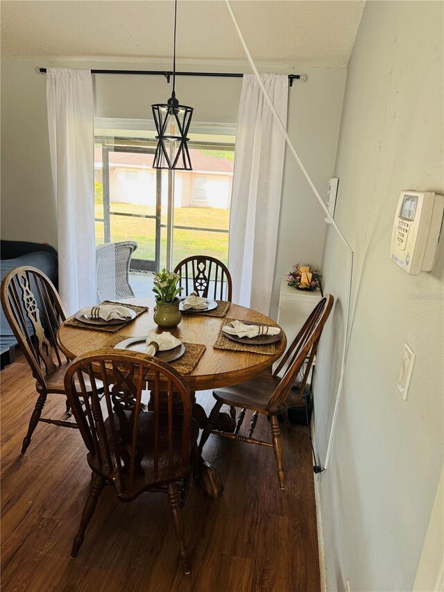dining space with wood finished floors and baseboards