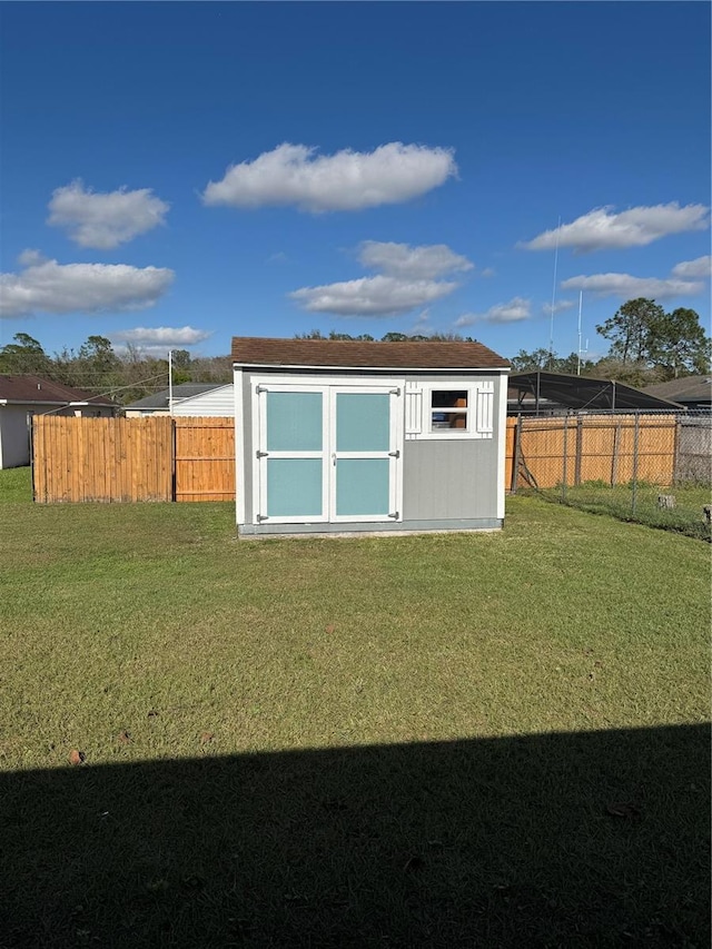 view of shed with a fenced backyard