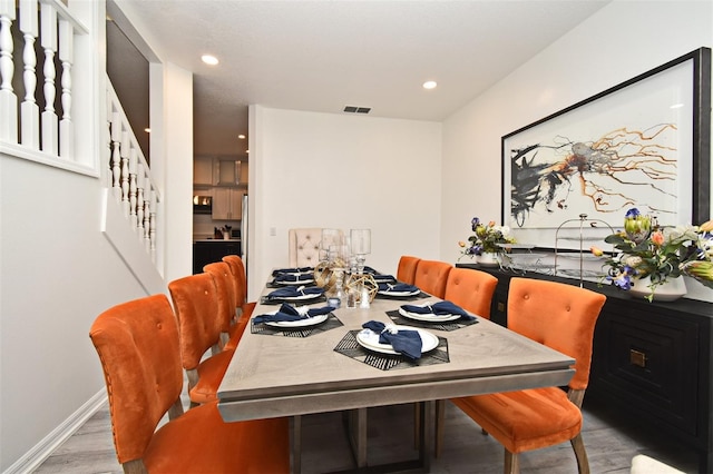 dining area with stairway, wood finished floors, visible vents, and recessed lighting