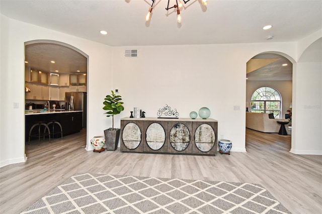 interior space with light wood finished floors, baseboards, visible vents, and recessed lighting