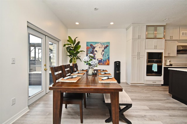 dining area featuring baseboards, french doors, light wood finished floors, and recessed lighting