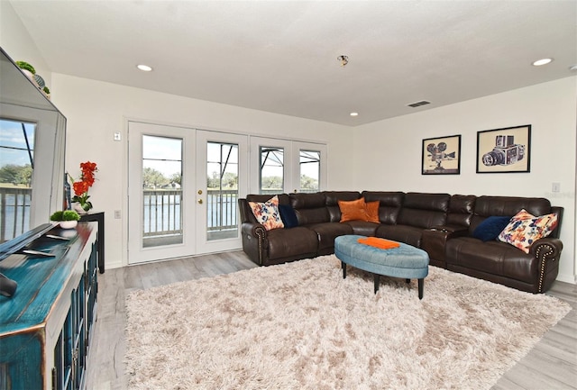 living area featuring light wood finished floors, french doors, visible vents, and recessed lighting