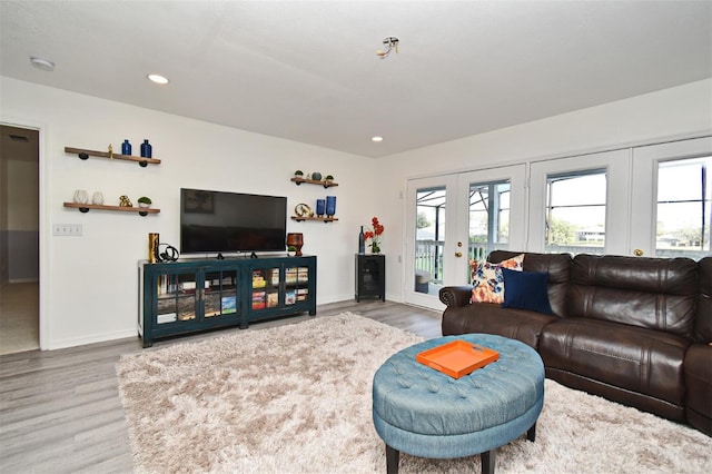 living area featuring recessed lighting, french doors, plenty of natural light, and wood finished floors