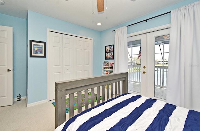 bedroom featuring light carpet, baseboards, access to outside, french doors, and a closet