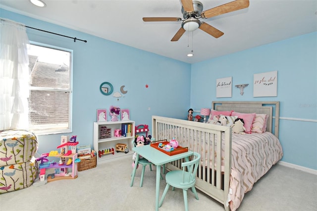 bedroom with a ceiling fan, light colored carpet, and baseboards